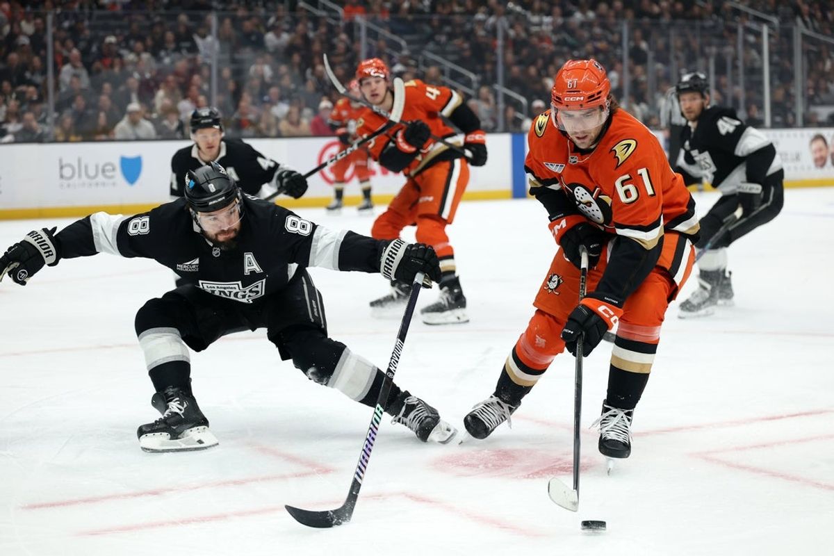 Jan 16, 2026; Los Angeles, California, USA;  Anaheim Ducks left wing Cutter Gauthier (61) skates with the puck against Los Angeles Kings defenseman Drew Doughty (8) during the first period at Crypto.com Arena. Mandatory Credit: Kiyoshi Mio-Imagn Images