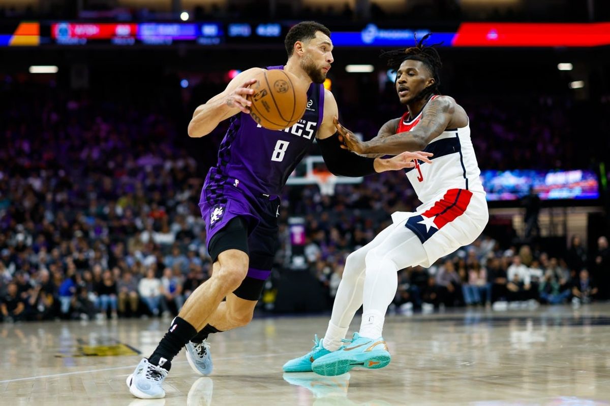 Jan 16, 2026; Sacramento, California, USA; Sacramento Kings guard Zach LaVine (8) drives against Washington Wizards guard Jamir Watkins (5) during the fourth quarter at Golden 1 Center. Mandatory Credit: Sergio Estrada-Imagn Images