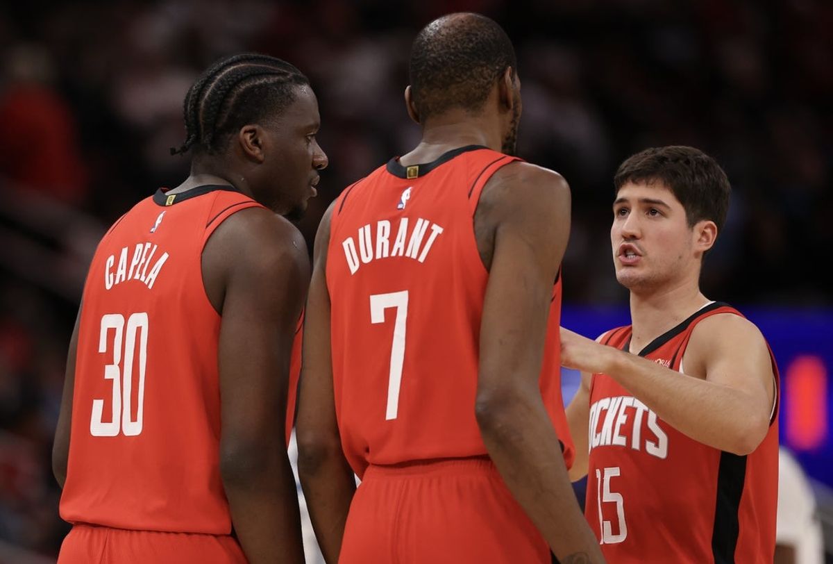 Jan 16, 2026; Houston, Texas, USA; Houston Rockets guard Reed Sheppard (15) talks to center Clint Capela (30) and  forward Kevin Durant (7) during a Minnesota Timberwolves timeout  in the second half at Toyota Center. Mandatory Credit: Thomas Shea-Imagn Images