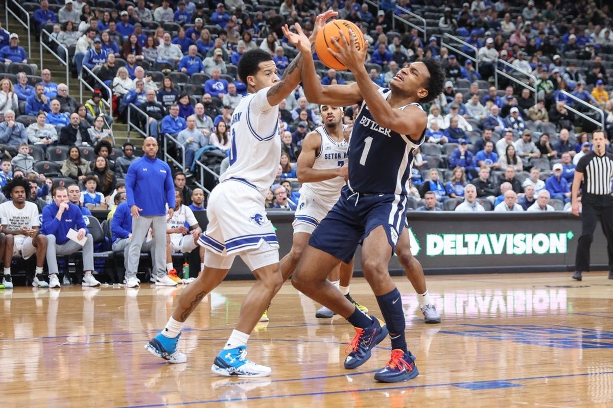 Jan 17, 2026; Newark, New Jersey, USA;  Seton Hall Pirates guard Adam Clark (0) and Butler Bulldogs guard Evan Haywood (1) fight for a loose ball in the first half at Prudential Center. Mandatory Credit: Wendell Cruz-Imagn Images