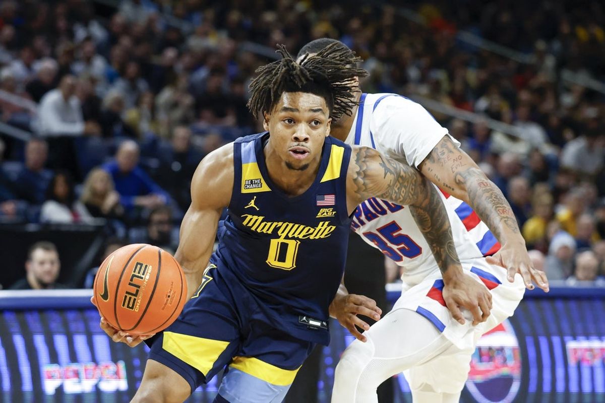 Jan 16, 2026; Chicago, Illinois, USA; Marquette Golden Eagles guard Nigel James Jr. (0) drives to the basket against DePaul Blue Demons forward N.J. Benson (35) during the first half at Wintrust Arena. Mandatory Credit: Kamil Krzaczynski-Imagn Images