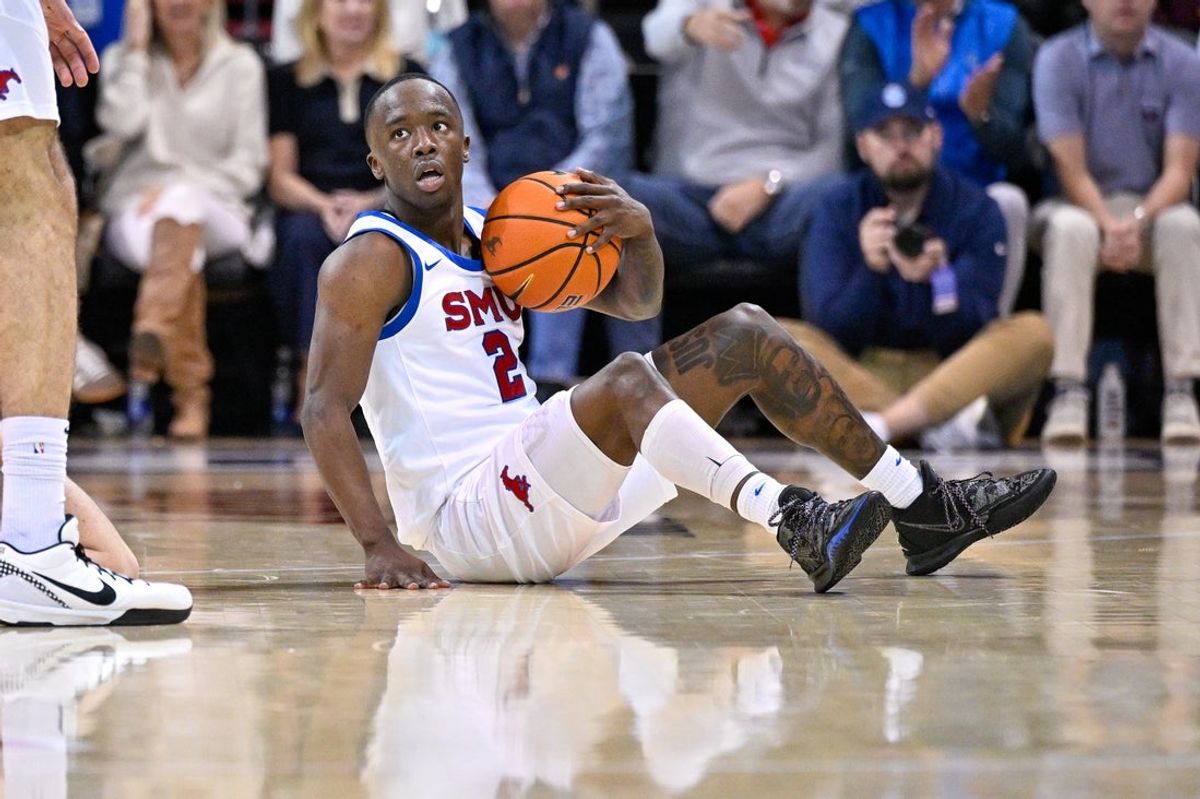 Jan 17, 2026; Dallas, Texas, USA; SMU Mustangs guard Boopie Miller (2) reacts to being knocked to the floor during the second half against the Virginia Cavaliers at Moody Coliseum. Mandatory Credit: Jerome Miron-Imagn Images