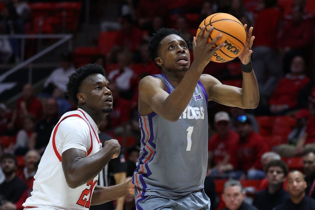 Jan 17, 2026; Salt Lake City, Utah, USA; TCU Horned Frogs guard Jayden Pierre (1) goes to the basket against Utah Utes guard Obomate Abbey (21) during the first half at Jon M. Huntsman Center. Mandatory Credit: Rob Gray-Imagn Images