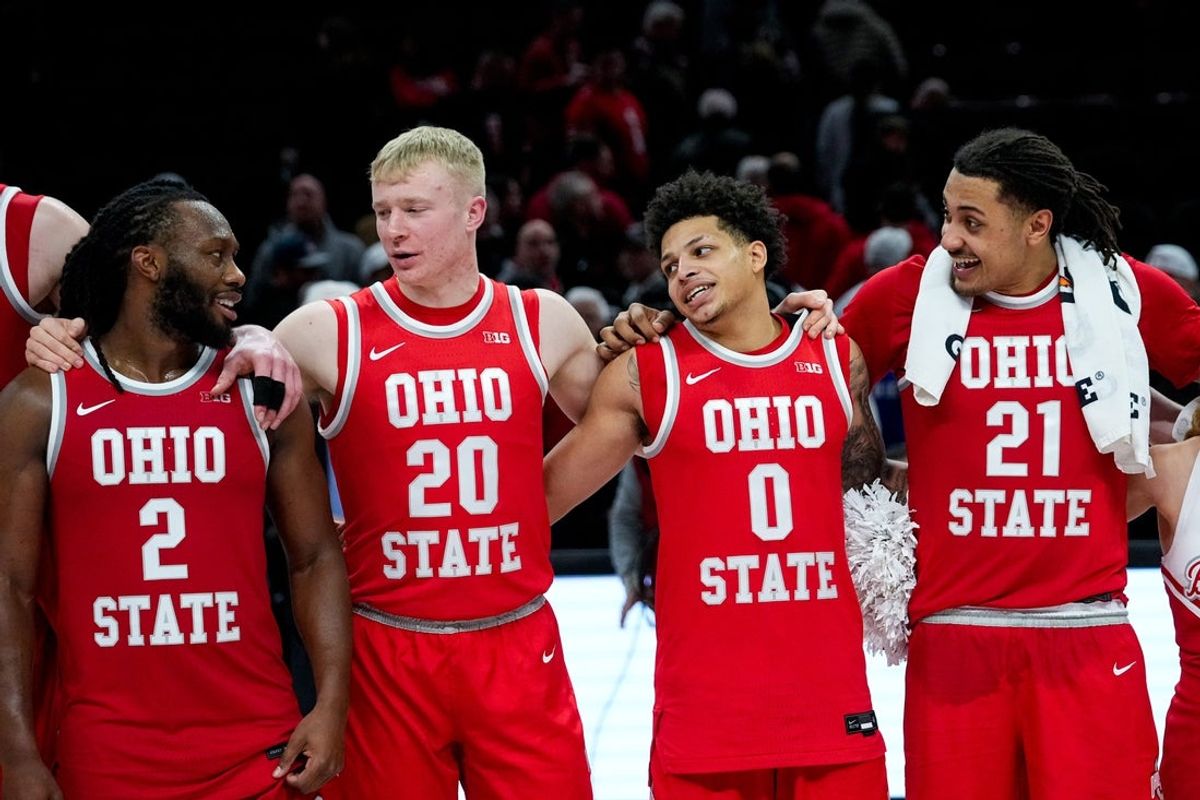 Ohio State Buckeyes guard Bruce Thornton (2), forward Colin White (20), guard John Mobley Jr. (0) and forward Devin Royal (21) sing “Carmen Ohio” after defeating the UCLA Bruins at Value City Arena on Saturday, Jan. 17, 2026 in Columbus, Ohio.