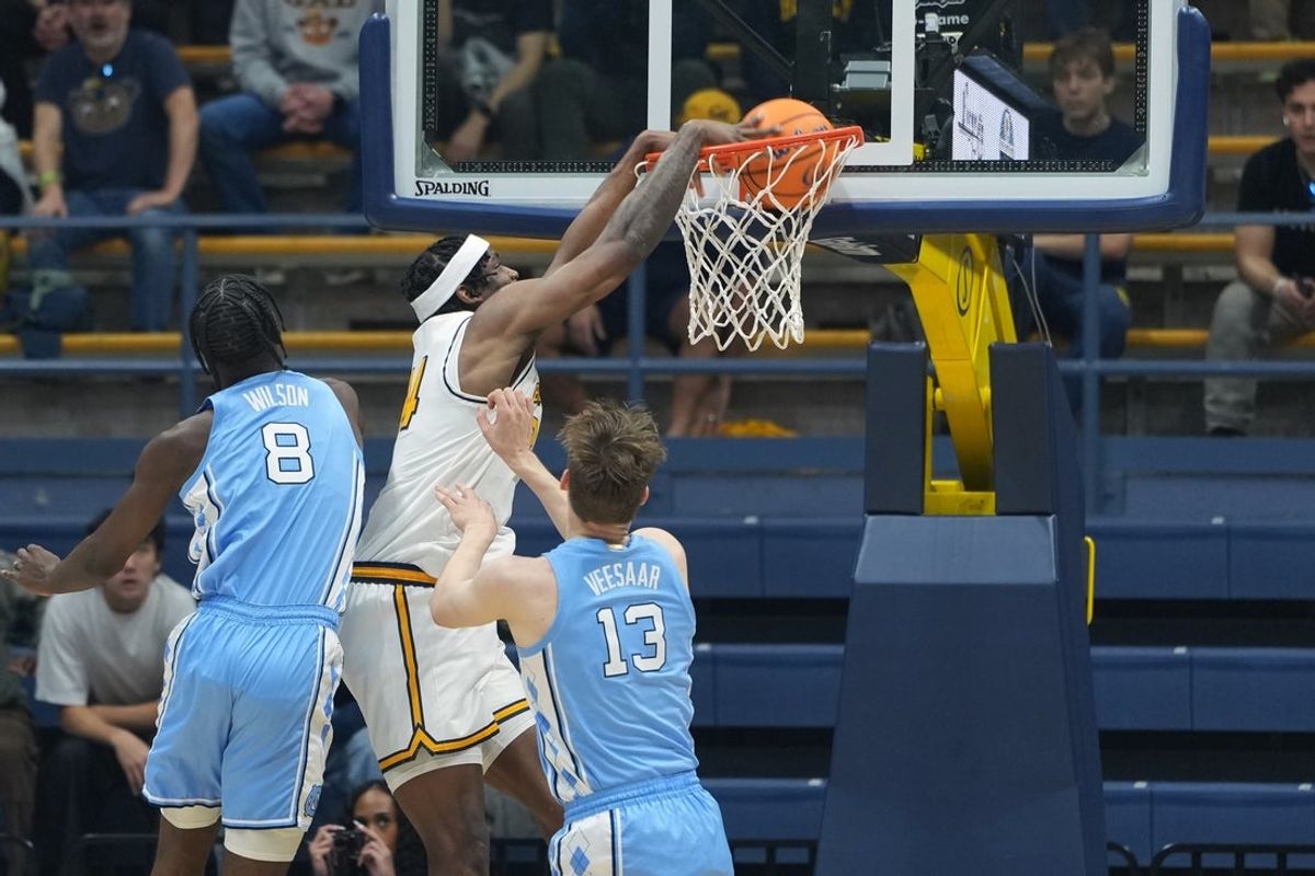 Jan 17, 2026; Berkeley, California, USA; California Golden Bears forward Lee Dort (center left) dunks against North Carolina Tar Heels forward Caleb Wilson (8) and center Henri Veesaar (13) during the first half at Haas Pavilion. Mandatory Credit: Darren Yamashita-Imagn Images