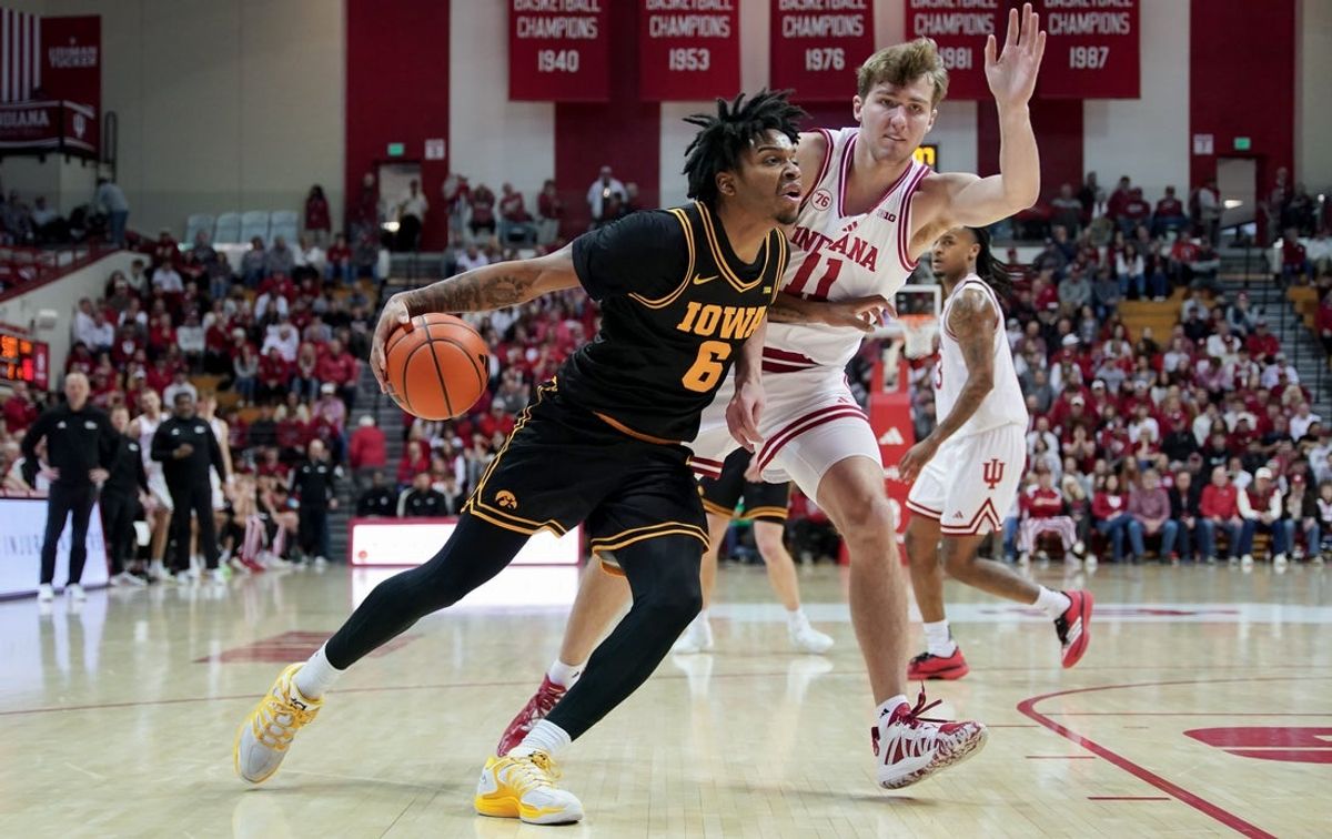 Jan 17, 2026; Bloomington, Indiana, USA; Iowa Hawkeyes guard Tavion Banks (6) goes to the basket against Indiana Hoosiers forward Trent Sisley (11) during the first half at Simon Skjodt Assembly Hall. Mandatory Credit: Robert Goddin-Imagn Images
