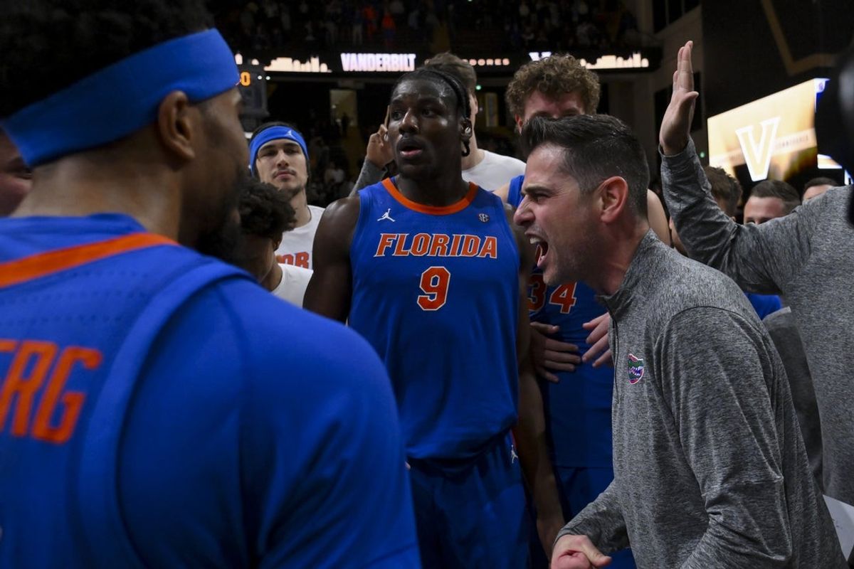 Jan 17, 2026; Nashville, Tennessee, USA;  Florida Gators head coach Todd Golden and center Rueben Chinyelu (9) celebrate the win with their team against the Vanderbilt Commodores during the second half at Memorial Gymnasium. Mandatory Credit: Steve Roberts-Imagn Images