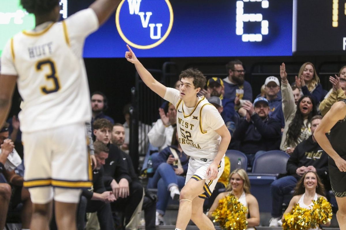 Jan 17, 2026; Morgantown, West Virginia, USA; West Virginia Mountaineers guard Treysen Eaglestaff (52) celebrates after a made three point basket during the first half against the Colorado Buffaloes at Hope Coliseum. Mandatory Credit: Ben Queen-Imagn Images