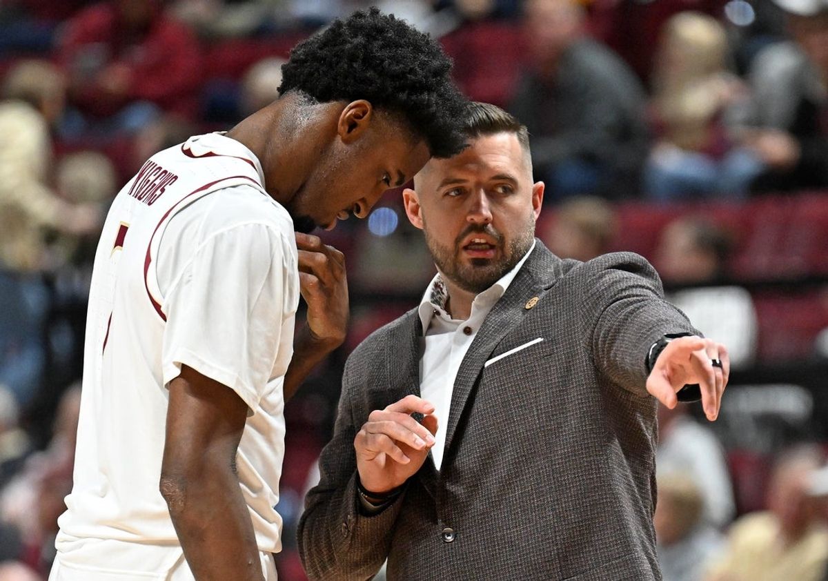 Jan 17, 2026; Tallahassee, Florida, USA; Florida State Seminoles head coach Luke Loucks talks with forward Chauncey Wiggins (7) during the first half against the Wake Forest Demon Deacons at Donald L. Tucker Center. Mandatory Credit: Melina Myers-Imagn Images