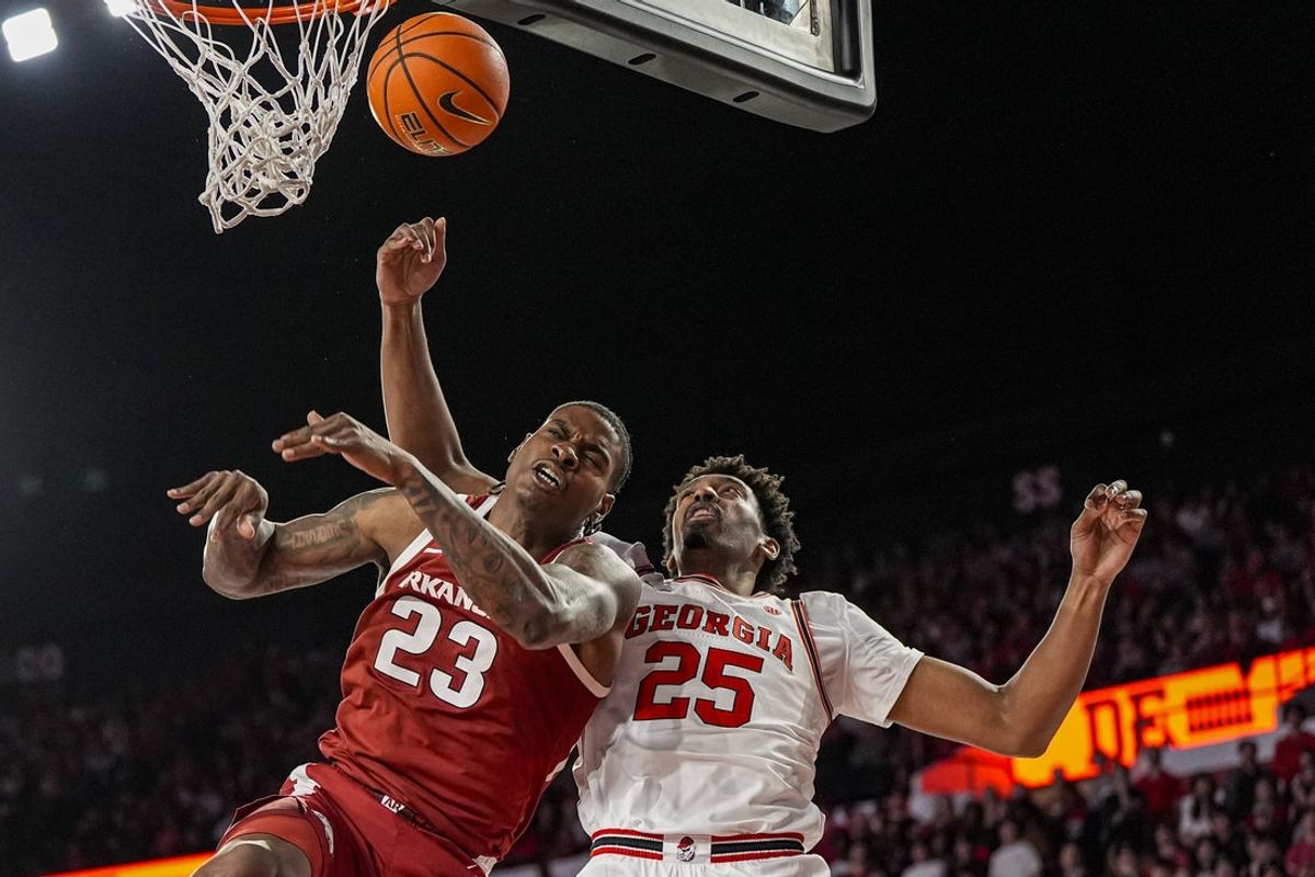 Jan 17, 2026; Athens, Georgia, USA; Arkansas Razorbacks forward Nick Pringle (23) and Georgia Bulldogs forward Justin Abson (25) battle for a rebound during the second half at Stegeman Coliseum. Mandatory Credit: Dale Zanine-Imagn Images