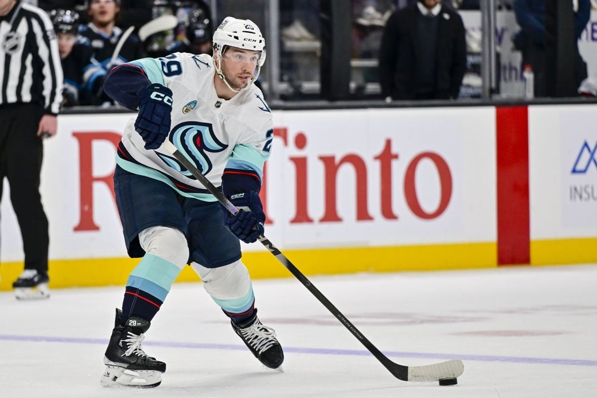 Jan 17, 2026; Salt Lake City, Utah, USA; Seattle Kraken defenseman Vince Dunn (29) makes a quick pass during the third period against the Utah Mammoth at Delta Center. Mandatory Credit: Peter Creveling-Imagn Images