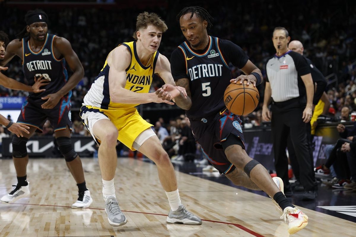Jan 17, 2026; Detroit, Michigan, USA;  Detroit Pistons forward Ronald Holland II (5) is defended by Indiana Pacers guard Johnny Furphy (12) in the first half at Little Caesars Arena. Mandatory Credit: Rick Osentoski-Imagn Images