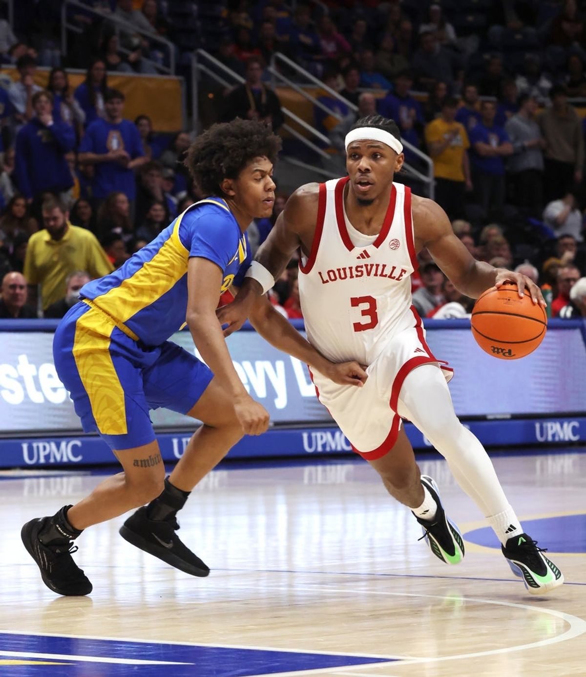 Jan 17, 2026; Pittsburgh, Pennsylvania, USA; Louisville Cardinals guard Ryan Conwell (3) drives to the basket against Pittsburgh Panthers guard Brandin Cummings (left) during the first half at the Petersen Events Center. Mandatory Credit: Charles LeClaire-Imagn Images