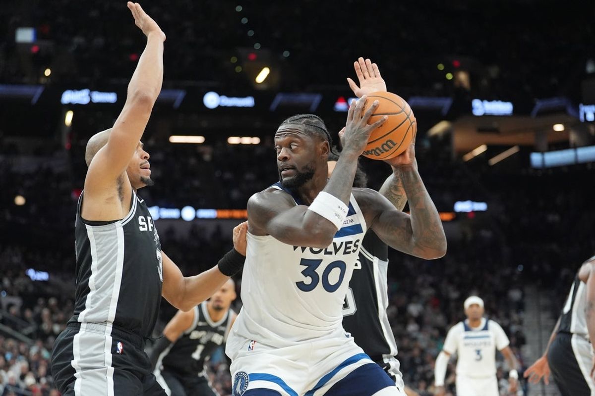 Jan 17, 2026; San Antonio, Texas, USA; Minnesota Timberwolves forward Julius Randle (30) keeps the ball from San Antonio Spurs forward Keldon Johnson (3) in the first half at Frost Bank Center. Mandatory Credit: Daniel Dunn-Imagn Images