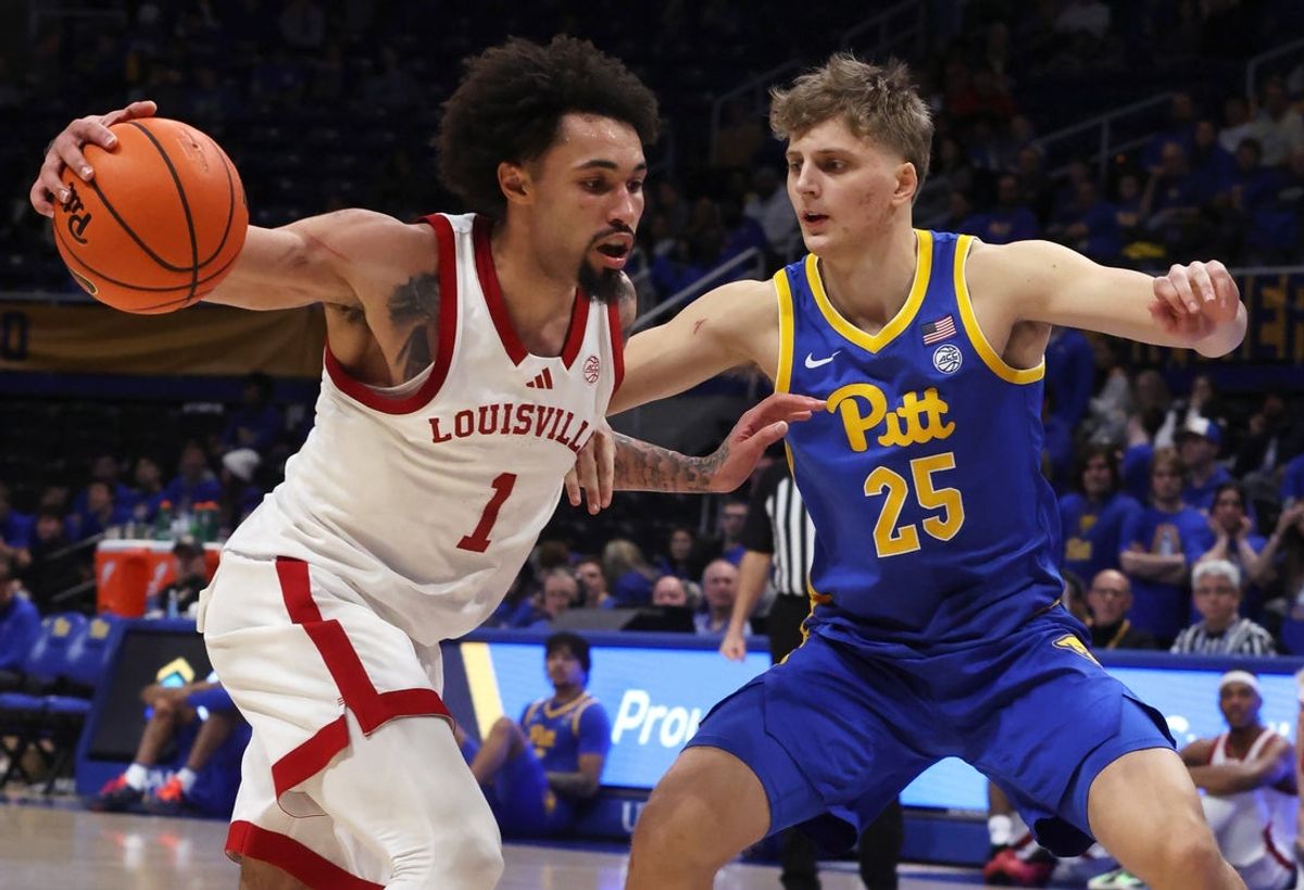 Jan 17, 2026; Pittsburgh, Pennsylvania, USA; Louisville Cardinals guard J'vonne Hadley (1) dribbles the ball as Pittsburgh Panthers guard Nojus Indrusaitis (25) defends during the second half at the Petersen Events Center. Mandatory Credit: Charles LeClaire-Imagn Images