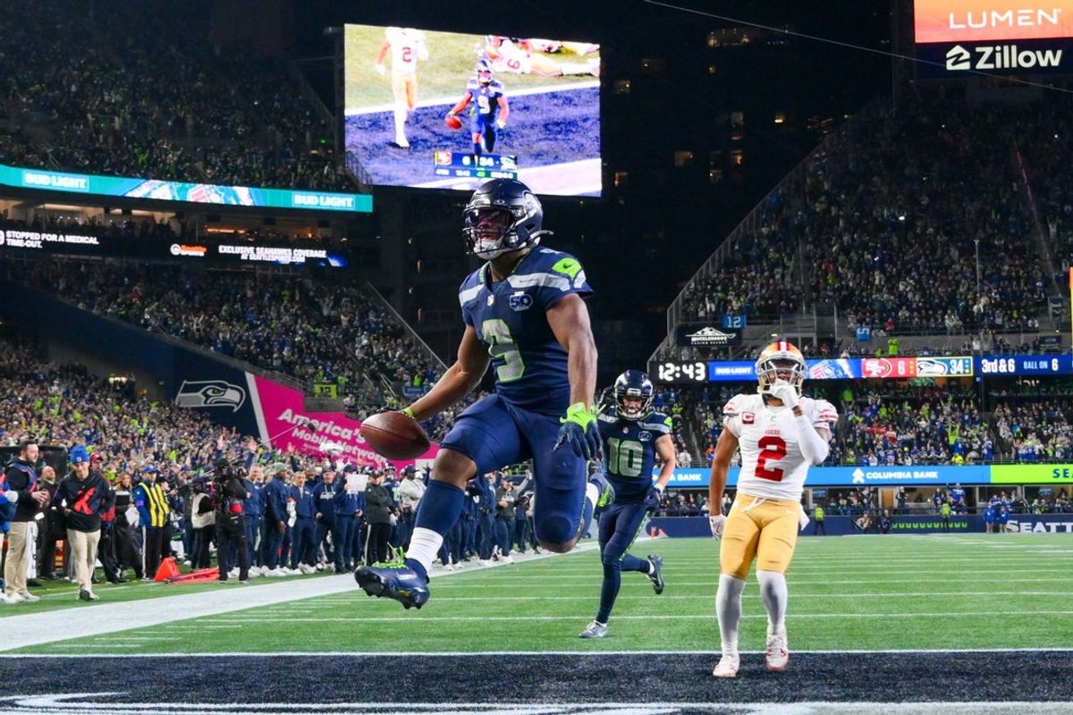 Jan 17, 2026; Seattle, WA, USA; Seattle Seahawks running back Kenneth Walker III (9) carries the ball for a touchdown as San Francisco 49ers cornerback Deommodore Lenoir (2) trails on the play during the second half in an NFC Divisional Round game at Lumen Field. Mandatory Credit: Steven Bisig-Imagn Images