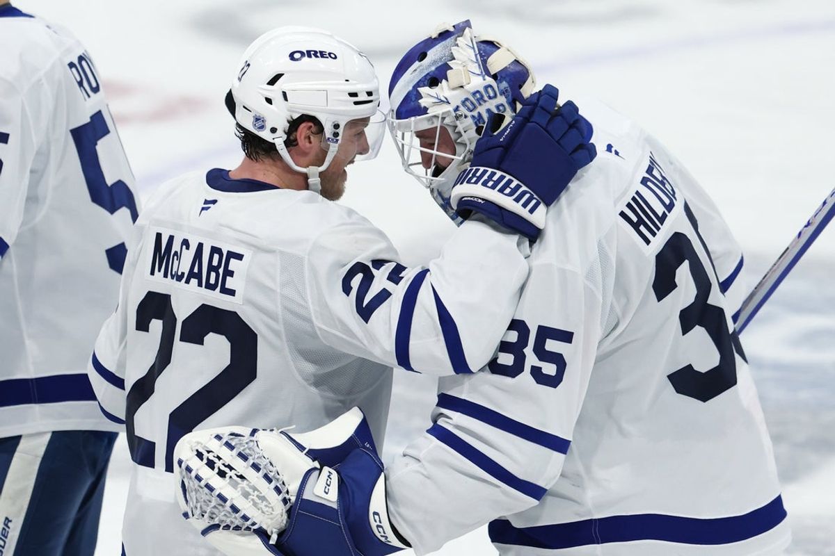 Jan 17, 2026; Winnipeg, Manitoba, CAN; Toronto Maple Leafs defenseman Jake McCabe (22) and Toronto Maple Leafs goaltender Dennis Hildeby (35) celebrate their victory over the Winnipeg Jets at Canada Life Centre. Mandatory Credit: James Carey Lauder-Imagn Images