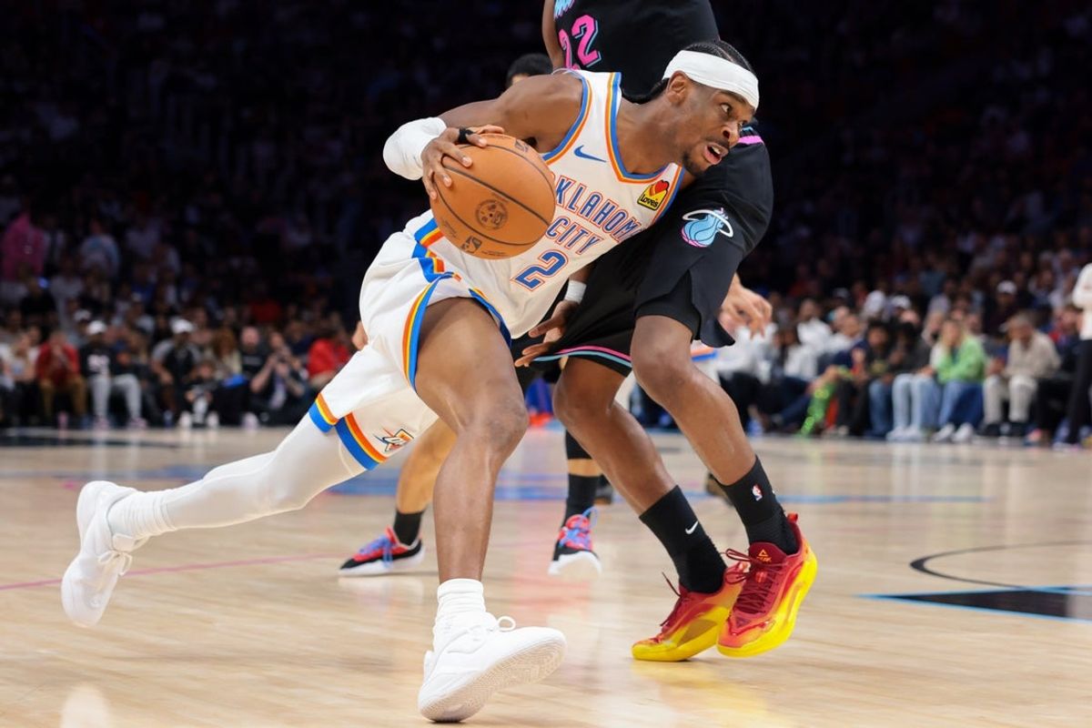 Jan 17, 2026; Miami, Florida, USA; Oklahoma City Thunder guard Shai Gilgeous-Alexander (2) drives to the basket against Miami Heat forward Andrew Wiggins (22) during the second quarter at Kaseya Center. Mandatory Credit: Sam Navarro-Imagn Images