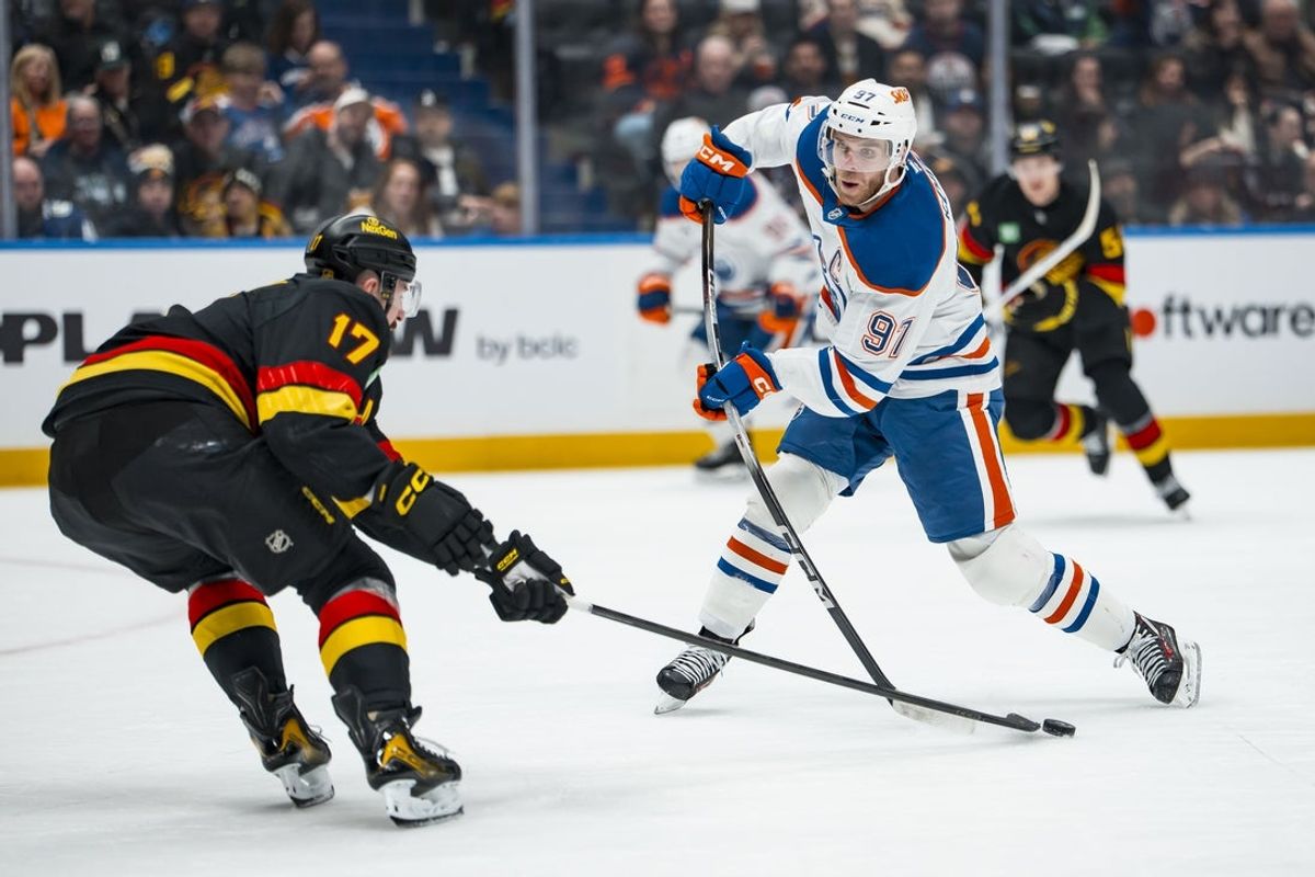 Jan 17, 2026; Vancouver, British Columbia, CAN; Vancouver Canucks defenseman Filip Hronek (17) stick checks Edmonton Oilers forward Connor McDavid (97) in the third period at Rogers Arena. Mandatory Credit: Bob Frid-Imagn Images