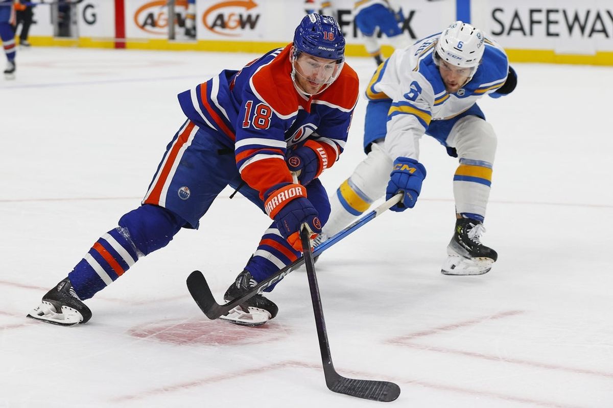 Jan 18, 2026; Edmonton, Alberta, CAN; Edmonton Oilers forward Zach Hyman (18) carries the puck around St. Louis Blues defensemen Phillip Broberg (6) during the first period at Rogers Place. Mandatory Credit: Perry Nelson-Imagn Images
