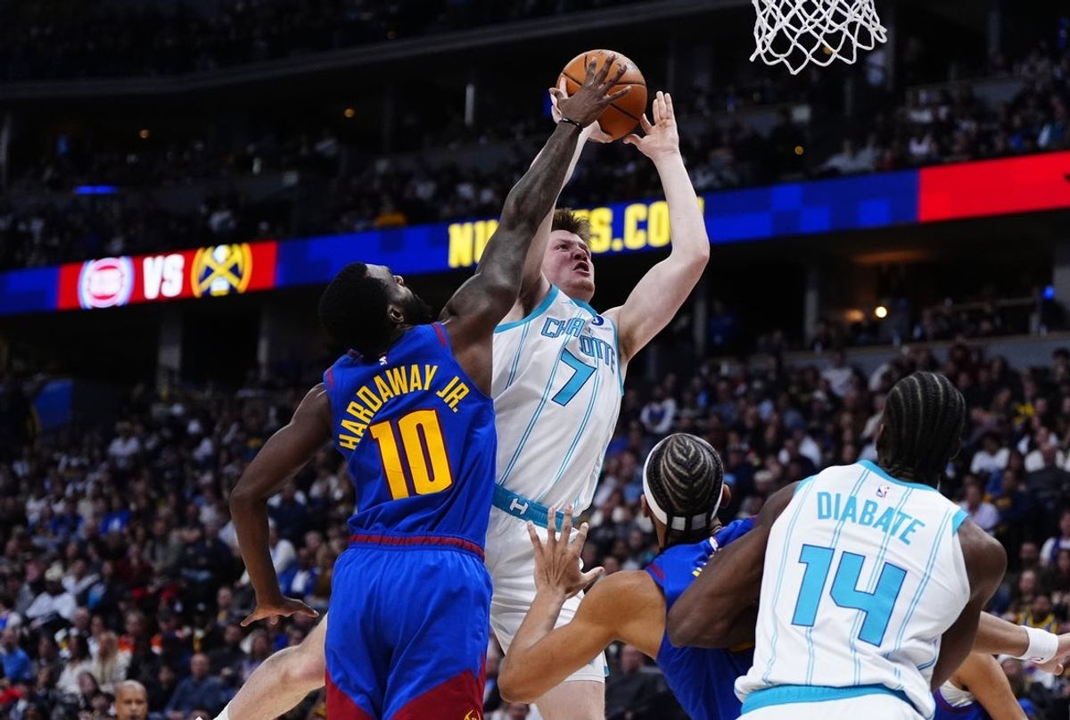 Jan 18, 2026; Denver, Colorado, USA; Charlotte Hornets guard Kon Knueppel (7) shoots past Denver Nuggets guard Tim Hardaway Jr. (10) in the second quarter at Ball Arena. Mandatory Credit: Ron Chenoy-Imagn Images
