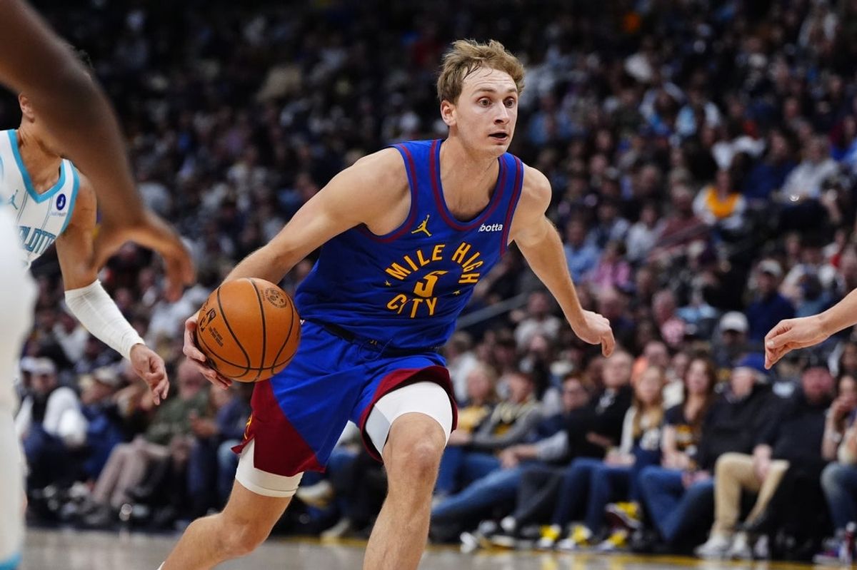 Jan 18, 2026; Denver, Colorado, USA; Denver Nuggets forward Hunter Tyson (5) dribbles in the second half against the Charlotte Hornets at Ball Arena. Mandatory Credit: Ron Chenoy-Imagn Images