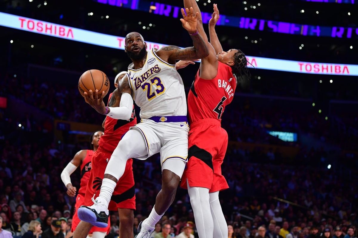 Jan 18, 2026; Los Angeles, California, USA; Los Angeles Lakers forward LeBron James (23) moves to the basket against Toronto Raptors forward Scottie Barnes (4) during the first half at Crypto.com Arena. Mandatory Credit: Gary A. Vasquez-Imagn Images