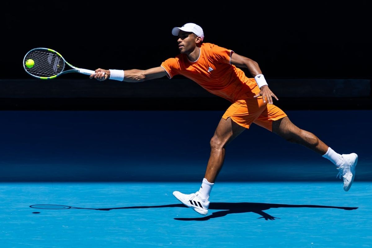 Jan 19, 2026; Melbourne, Victoria, Australia; Felix Auger-Aliassime of Canada in action against Nuno Borges of Portugal in the first round of the men’s singles at the Australian Open at John Cain Arena in Melbourne Park. Mandatory Credit: Mike Frey-Imagn Images