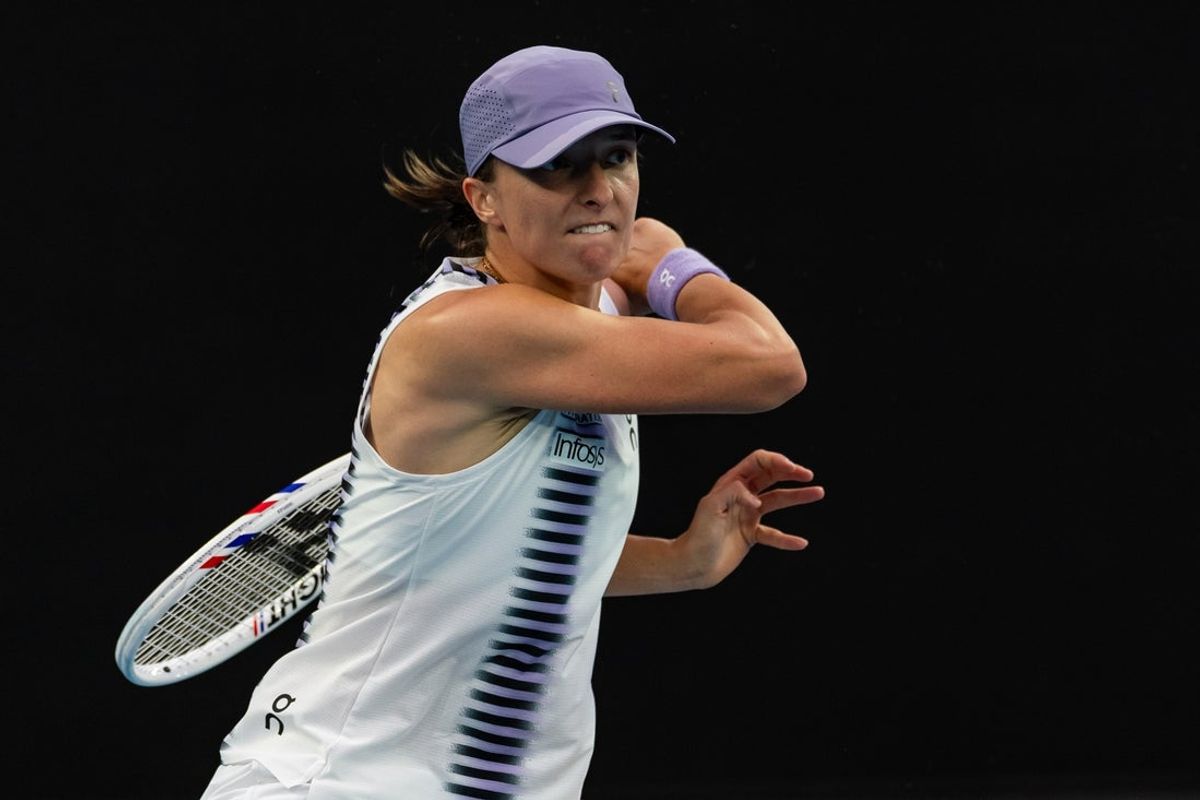 Jan 19, 2026; Melbourne, Victoria, Australia; Iga Swiatek of Poland in action against Yue Yuan of China in the first round of the women’s singles at the Australian Open at Rod Laver Arena in Melbourne Park. Mandatory Credit: Mike Frey-Imagn Images