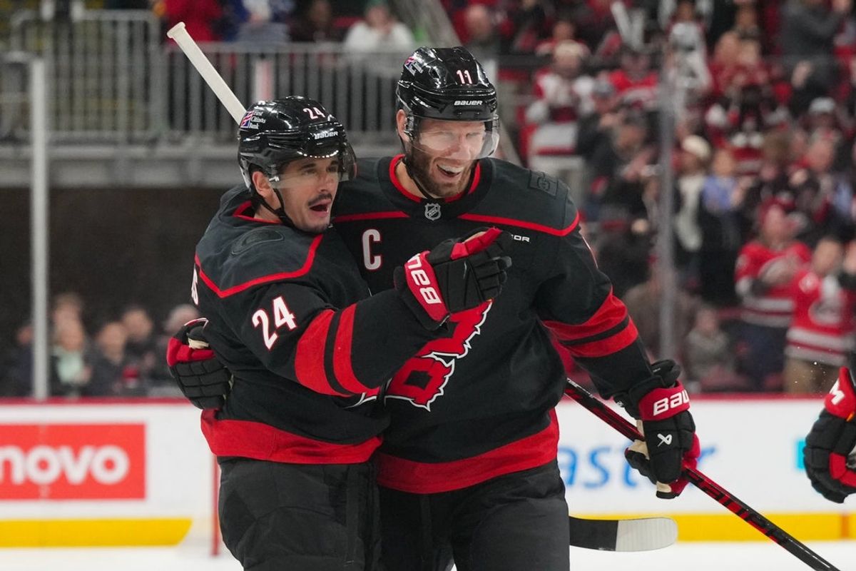 Jan 19, 2026; Raleigh, North Carolina, USA;  Carolina Hurricanes center Seth Jarvis (24) celebrates his goal with center Jordan Staal (11) against the Buffalo Sabres during the third period at Lenovo Center. Mandatory Credit: James Guillory-Imagn Images