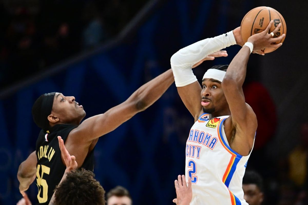 Jan 19, 2026; Cleveland, Ohio, USA; Oklahoma City Thunder guard Shai Gilgeous-Alexander (2) looks to pass against Cleveland Cavaliers forward Nae'qwan Tomlin (35) during the second half at Rocket Arena. Mandatory Credit: Ken Blaze-Imagn Images