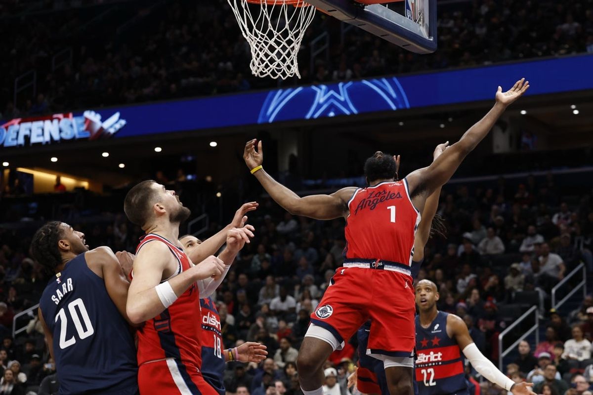 Jan 19, 2026; Washington, District of Columbia, USA; LA Clippers guard James Harden (1) is fouled while shooting by Washington Wizards guard Tre Johnson (12) in the final seconds in the fourth quarter at Capital One Arena. Mandatory Credit: Geoff Burke-Imagn Images