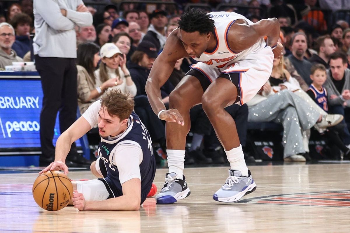 Jan 19, 2026; New York, New York, USA;  Dallas Mavericks forward Cooper Flagg (32) and New York Knicks forward Og Anunoby (8) fight for a loose ball in the first quarter at Madison Square Garden. Mandatory Credit: Wendell Cruz-Imagn Images
