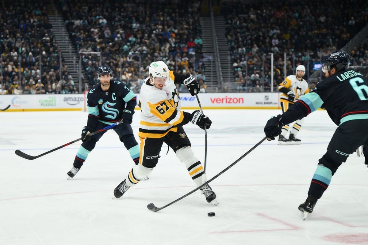 Jan 19, 2026; Seattle, Washington, USA; Pittsburgh Penguins right wing Rickard Rakell (67) shoots the puck against the Seattle Kraken during the second period at Climate Pledge Arena. Mandatory Credit: Steven Bisig-Imagn Images