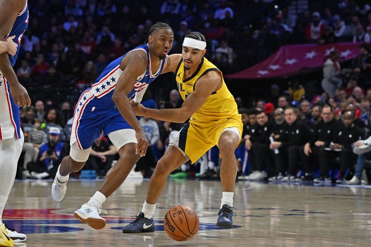 Jan 19, 2026; Philadelphia, Pennsylvania, USA; Philadelphia 76ers guard Tyrese Maxey (0) drivers past Indiana Pacers guard Andrew Nembhard (2) during the first quarter at Xfinity Mobile Arena. Mandatory Credit: Eric Hartline-Imagn Images