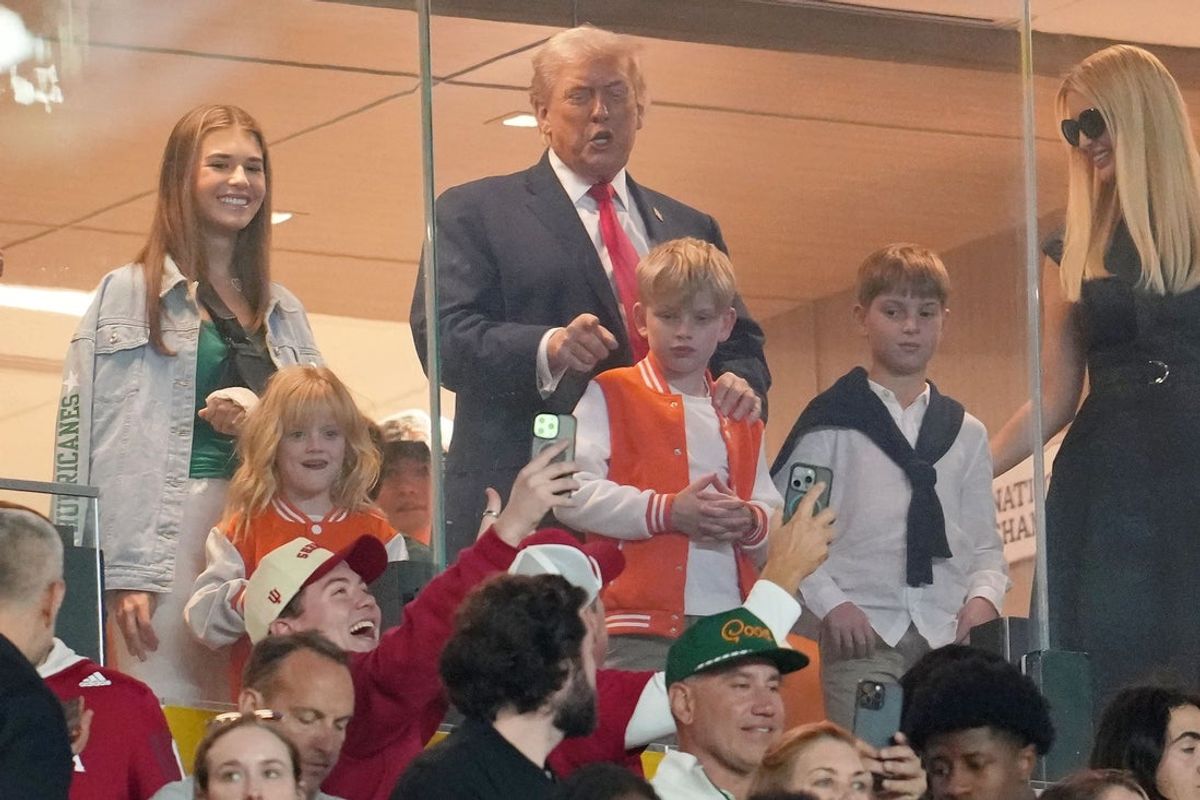 Jan 19, 2026; Miami Gardens, FL, USA; United States President Donald Trump reacts as a fan takes a photo before the CFP National Championship college football game between the Indiana Hoosiers and the Miami Hurricanes at Hard Rock Stadium. Mandatory Credit: Kirby Lee-Imagn Images