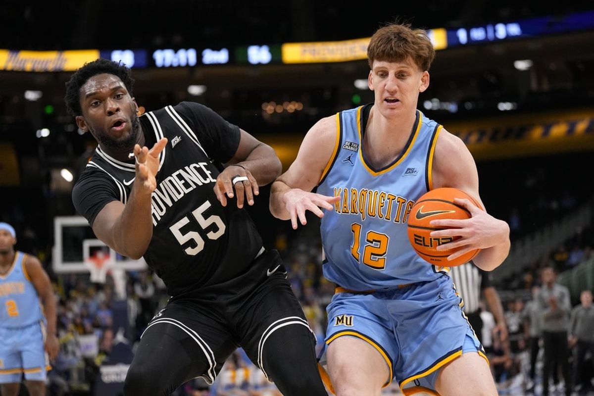 Jan 19, 2026; Milwaukee, Wisconsin, USA;  Marquette Golden Eagles forward Ben Gold (12) keeps the ball away from Providence Friars forward Oswin Erhunmwunse (55) during the second half at Fiserv Forum. Mandatory Credit: Jeff Hanisch-Imagn Images