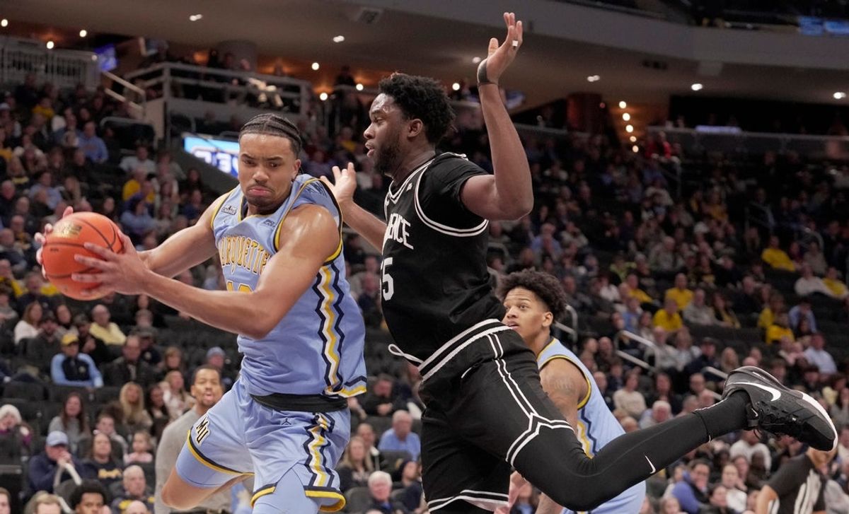 Marquette forward Royce Parham (13) out rebounds Providence forward Oswin Erhunmwunse (55) during the second half their game Monday, January 19, 2026 at Fiserv Forum in Milwaukee, Wisconsin. Marquette beat Providence 105-104 in overtime.
