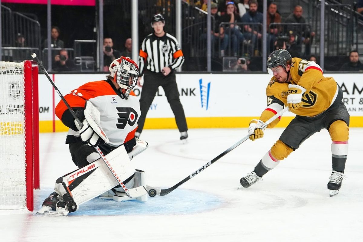 Jan 19, 2026; Las Vegas, Nevada, USA; Philadelphia Flyers goaltender Samuel Ersson (33) makes a save against Vegas Golden Knights right wing Alexander Holtz (26) during the first period at T-Mobile Arena. Mandatory Credit: Stephen R. Sylvanie-Imagn Images