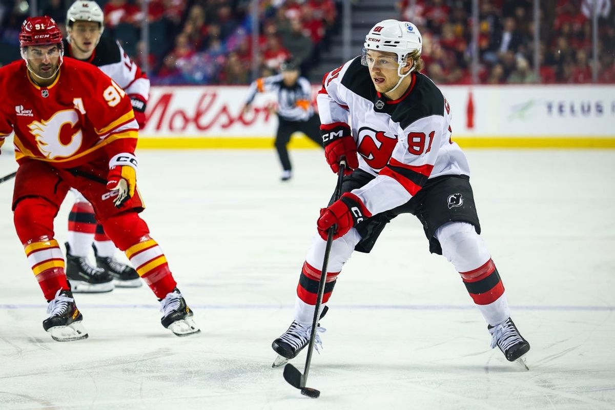 Jan 19, 2026; Calgary, Alberta, CAN; New Jersey Devils center Dawson Mercer (91) controls the puck against the Calgary Flames during the first period at Scotiabank Saddledome. Mandatory Credit: Sergei Belski-Imagn Images