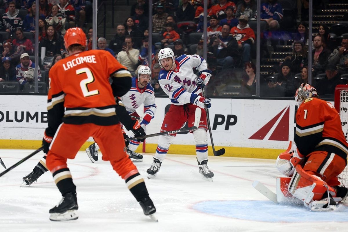 Jan 19, 2026; Anaheim, California, USA;  New York Rangers center Jonny Brodzinski (22) shoots the puck against Anaheim Ducks goaltender Lukas Dostal (1) during the first period at Honda Center. Mandatory Credit: Kiyoshi Mio-Imagn Images