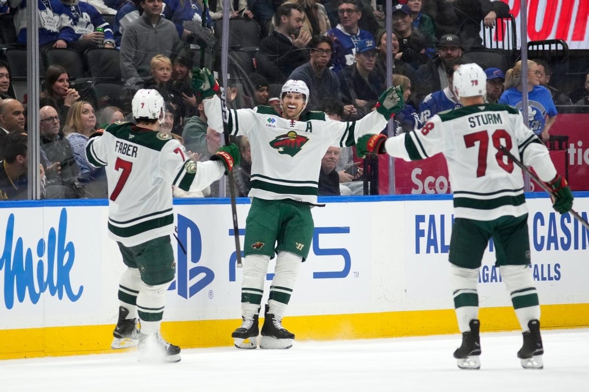 Jan 19, 2026; Toronto, Ontario, CAN; Minnesota Wild forward Marcus Foligno (17) celebrates with defenseman Brock Faber (7) and forward Nico Sturm (78) after scoring his third goal of the game against the Toronto Maple Leafs during the third period at Scotiabank Arena. Mandatory Credit: John E. Sokolowski-Imagn Images