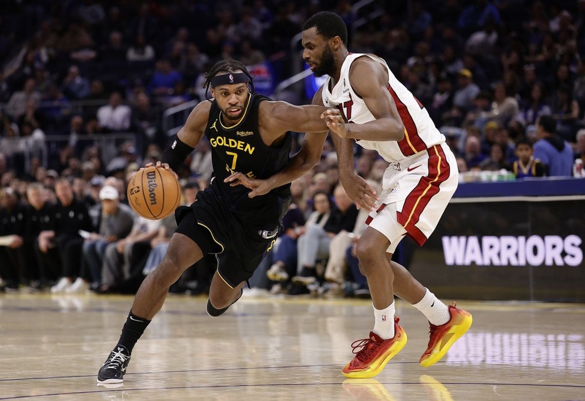 Jan 19, 2026; San Francisco, California, USA; Golden State Warriors guard Buddy Hield (7) controls the ball against Miami Heat forward Andrew Wiggins (22) during the fourth quarter at Chase Center. Mandatory Credit: Kelley L Cox-Imagn Images