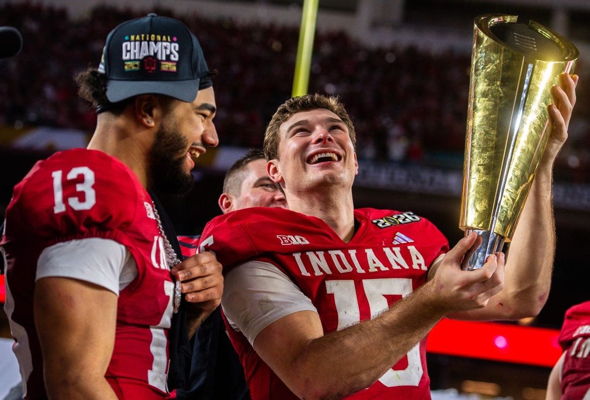 Indiana's Elijah Sarratt (13) watches as Ferenando Mendoza (15) raises the trophy after the College Football Playoff National Championship college football game at Hard Rock Stadium in Miami Gardens on Monday, Jan. 19, 2026.
