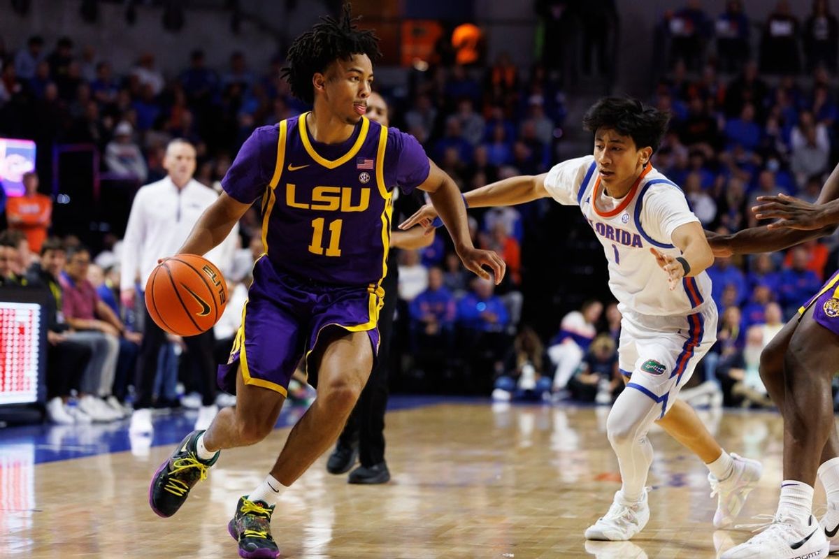 Jan 20, 2026; Gainesville, Florida, USA; Louisiana State Tigers guard Dedan Thomas Jr. (11) drives to the basket past Florida Gators guard Xaivian Lee (1) during the first half at Exactech Arena at the Stephen C. O'Connell Center. Mandatory Credit: Matt Pendleton-Imagn Images