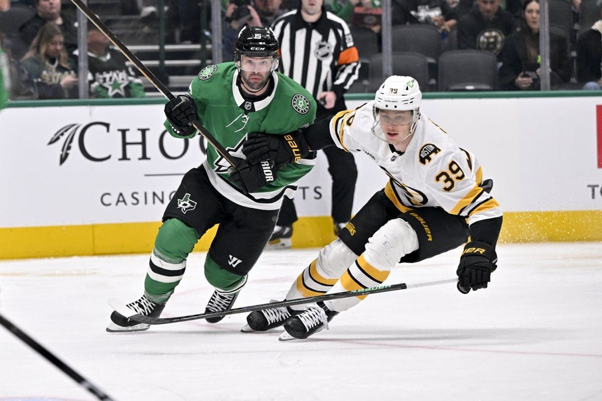 Jan 20, 2026; Dallas, Texas, USA;  Dallas Stars center Colin Blackwell (15) and Boston Bruins center Morgan Geekie (39) chase the puck during the first period at the American Airlines Center. Mandatory Credit: Jerome Miron-Imagn Images