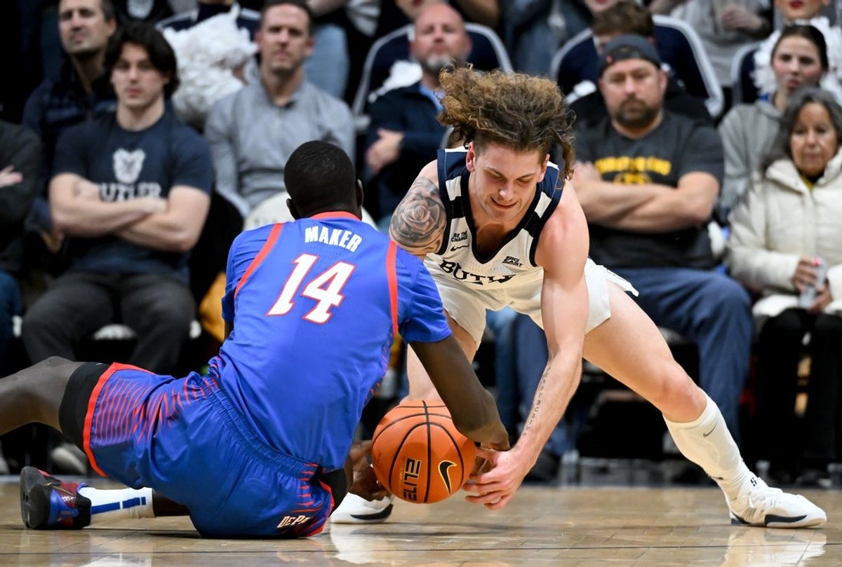 Jan 20, 2026; Indianapolis, Indiana, USA; DePaul Blue Demons center Khaman Maker (14) and Butler Bulldogs guard Finley Bizjack (11) go after a loose ball during the first half at Hinkle Fieldhouse. Mandatory Credit: Robert Goddin-Imagn Images