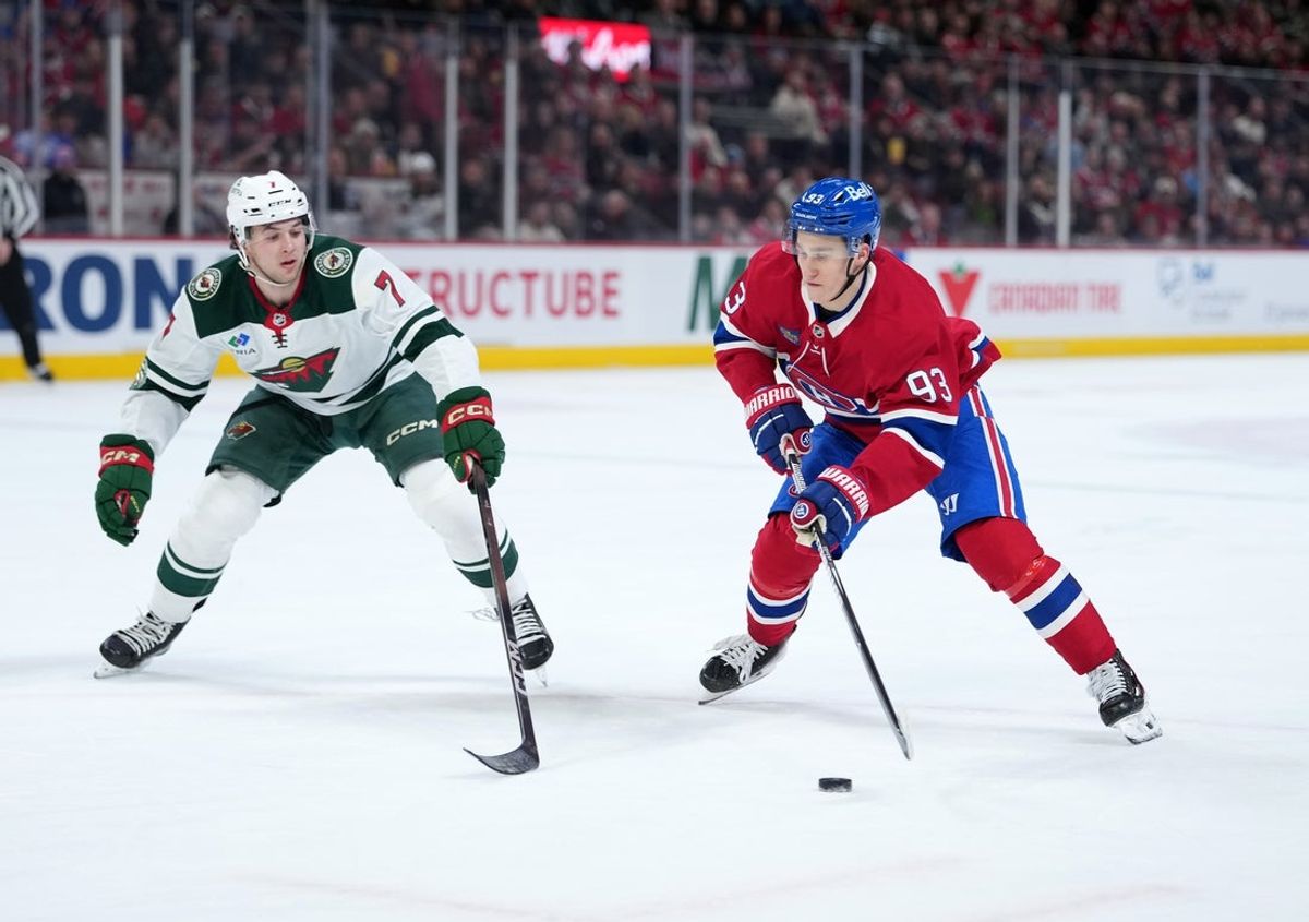 Jan 20, 2026; Montreal, Quebec, CAN; Montreal Canadiens forward Ivan Demidov (93) plays the puck and Minnesota Wild defenseman Brock Faber (7) defends during the second period at the Bell Centre. Mandatory Credit: Eric Bolte-Imagn Images