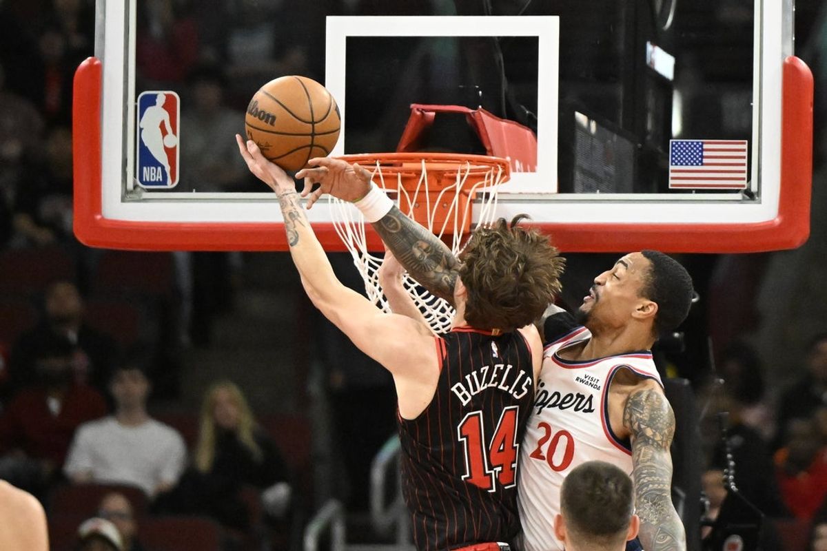 Jan 20, 2026; Chicago, Illinois, USA; Chicago Bulls forward Matas Buzelis (14) shoots against LA Clippers forward John Collins (20) during the first half at United Center. Mandatory Credit: Matt Marton-Imagn Images