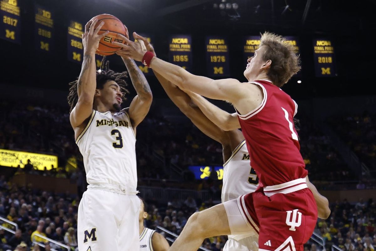 Jan 20, 2026; Ann Arbor, Michigan, USA;  Michigan Wolverines guard Elliot Cadeau (3) grabs the rebound over Indiana Hoosiers forward Reed Bailey (1) in the second half at Crisler Center. Mandatory Credit: Rick Osentoski-Imagn Images
